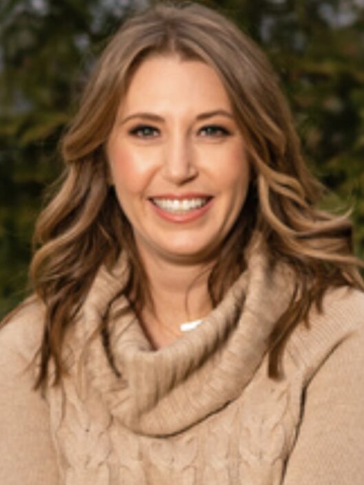Laura Barney, McLean's Co-Director of Communications and Marketing, smiling for the camera